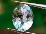 un gros plan d'un diamant tenu par une paire de pinces