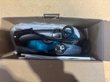 a box with a pair of shoes and a pair of scissors in it