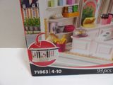 a box with a picture of a doll house inside of it