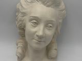 a statue of a woman that is on a table