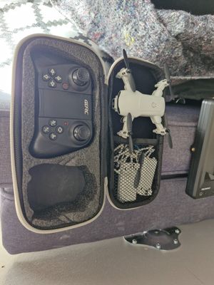 a suitcase with a remote control and other items in it