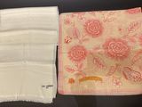 two napkins that are sitting on a table