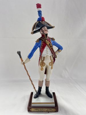 figurine of a man in a military uniform holding a cane