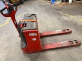 a red forklift with a black handle in a warehouse