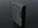 an image of a lighter sitting on a black surface