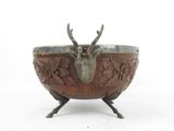 an image of a metal bowl with a deer head on it