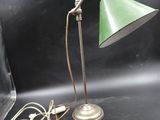 an image of a green lamp on a table next to a laptop