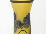 a yellow vase with black and white flowers on it