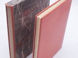 two books sitting next to each other on a white surface