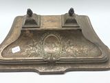 a silver plate with a picture on it on a white surface