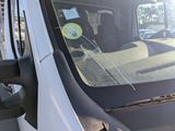 a white van with a yellow sticker on the windshield