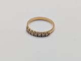 a close up of a gold ring on a white surface