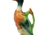a small ceramic duck that is sitting on the ground