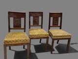 three wooden chairs with yellow upholstered seats on a gray background