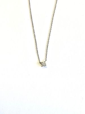 silver chain with a diamond pendant on a mannequin neck