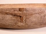 a large wooden bowl with a cross on it
