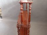 a small wooden table with a bird on top of it