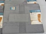 several folded towels on a white table with blue labels on them