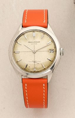 a watch that is sitting on a white surface