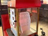 a popcorn machine sitting on a table in a restaurant