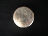 a small silver object on a black surface