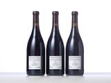 three bottles of wine sitting on top of a white table