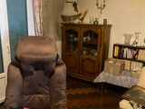 a brown recliner chair in a living room with a pink blanket
