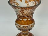 a glass vase that has a flower design on it