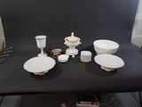 a black table with a bunch of white plates and bowls on it