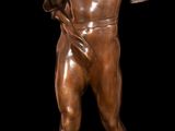 an image of a bronze statue of a man holding a bag