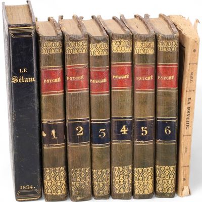 plusieurs vieux livres sont alignés sur une surface blanche