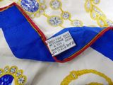 a close up of a blue and white scarf with a red trim