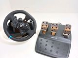 a steering wheel and two pedals on a table