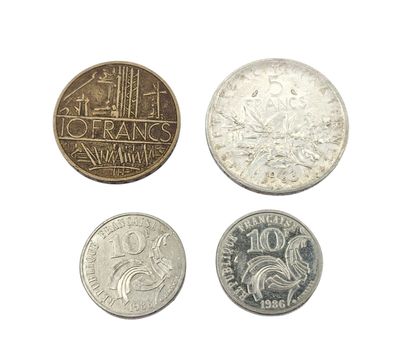four different types of coins are shown on a white surface
