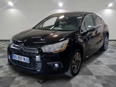 the black car is parked on a checkered floor in the garage