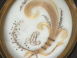 a picture of a decorative plate with a monogram on it