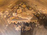 a wooden table with a painting of flowers on it