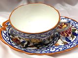 a cup and saucer on a saucer on a white cloth