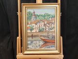 a painting on a easel with a picture of a boat in the water