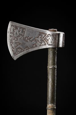 a close up of an old axe on a black background