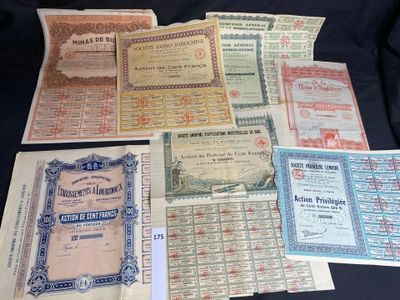 several different types of old paper certificates on a black surface