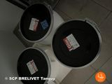 three black and white buckets sitting on top of a white toilet
