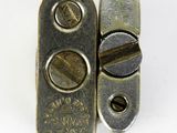 a close up of a metal latch on a white surface