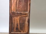 an image of a wooden cabinet sitting on top of a carpeted floor