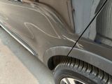 a close up of a car ' s side door and tire