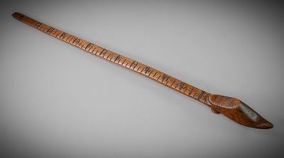 an old wooden instrument with a long neck and a wooden handle