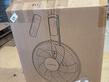 cardboard box with a drawing of a fan on it sitting on a table