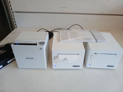three white boxes sitting next to each other on a table