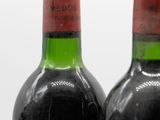 two bottles of wine sitting next to each other on a table