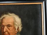 portrait of a man with white hair and a green jacket